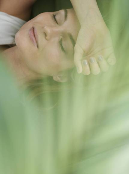 daydreaming-woman-blurred-house-plant